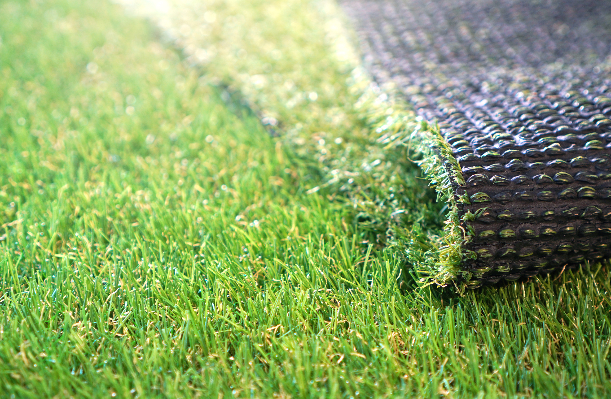 Greenering with an artificial grass. Artificial turf background.